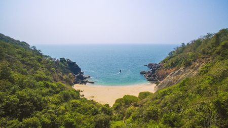 Aerial view of secret pristine Butterfly beach with rocky bay and waves crashingの写真素材