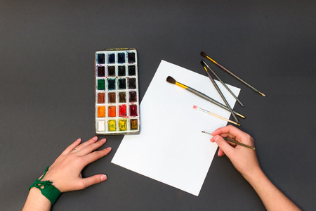 watercolors and hand with brushの写真素材