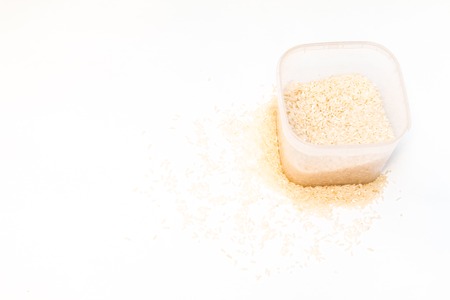 Buckwheat is sprinkled / premium buckwheat groats on white backgroundの写真素材