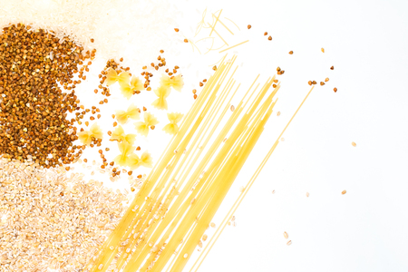 Buckwheat is sprinkled / premium buckwheat groats on white backgroundの写真素材