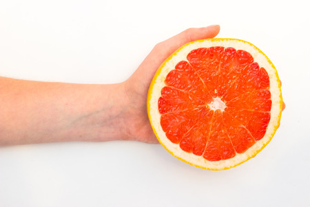 Grapefruit with slice on white background, top viewの写真素材