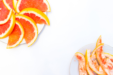 Grapefruit with slice on white background, top viewの写真素材