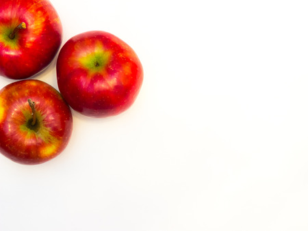 juicy, ripe apples in different colors on a white backgroundの写真素材