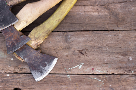several axes lying on a wooden table in the countryside, in the summerの写真素材