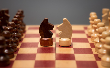wooden chess board and pieces on a black backgroundの写真素材