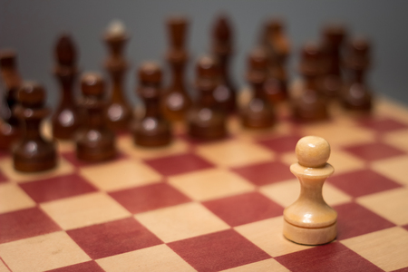 wooden chess board and pieces on a black backgroundの写真素材