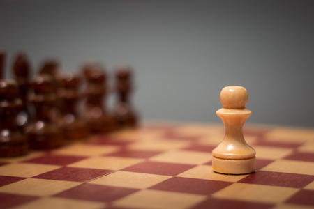 wooden chess board and pieces on a black backgroundの写真素材
