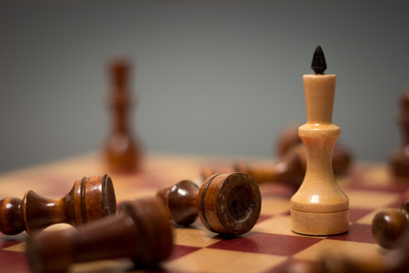 wooden chess board and pieces on a black backgroundの写真素材