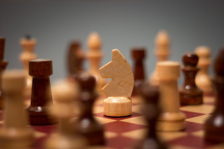 wooden chess board and pieces on a black backgroundの写真素材