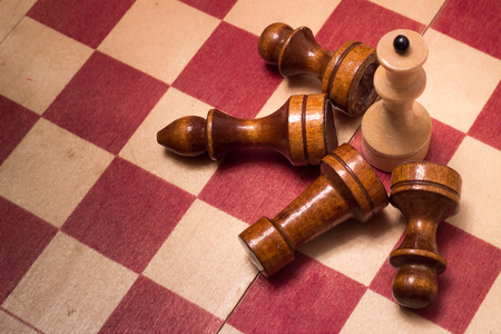 wooden chess board and pieces on a black backgroundの写真素材