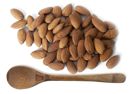 almonds and wooden spoon isolated on white backgroundの写真素材