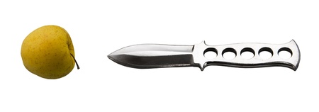 sharp blade throwing knife and yellow apple isolated white