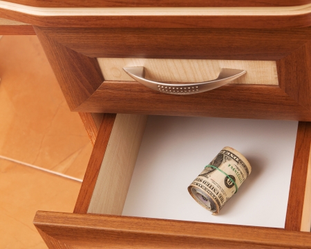roll of United States dollars in open desk  drawerの写真素材