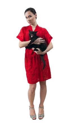 young girl in red dressing gown with kitten isolated whiteの写真素材