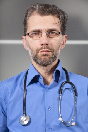 doctor with stethoscope and glasses in clinicの写真素材
