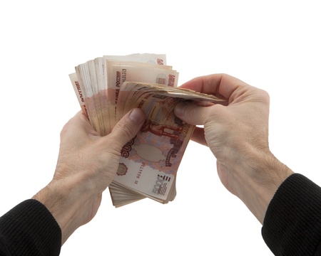 man s hands recalculates cash in Russian rubles on white