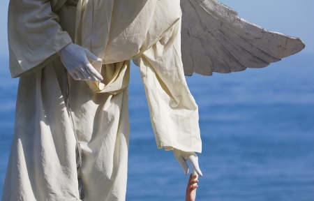 animator with angel wings on the shore of seaの写真素材