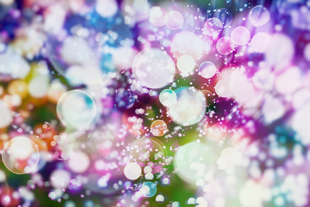 Abstract Festive background. Glitter vintage lights background with lights defocused.