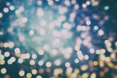 Abstract Festive background. Glitter vintage lights background with lights defocused.