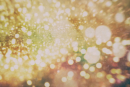 Abstract Festive background. Glitter vintage lights background with lights defocused.の写真素材