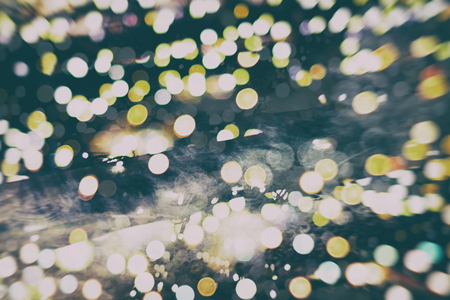 Abstract Festive background. Glitter vintage lights background with lights defocused.
