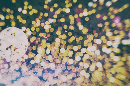 Abstract Festive background. Glitter vintage lights background with lights defocused.