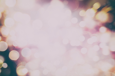 Abstract Festive background. Glitter vintage lights background with lights defocused.