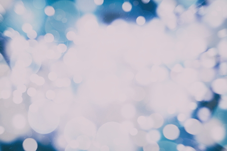 Abstract Festive background. Glitter vintage lights background with lights defocused.