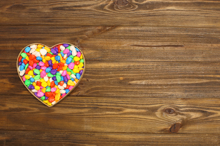 Heart of stones in the shape of a heart on a wooden Boardsの写真素材