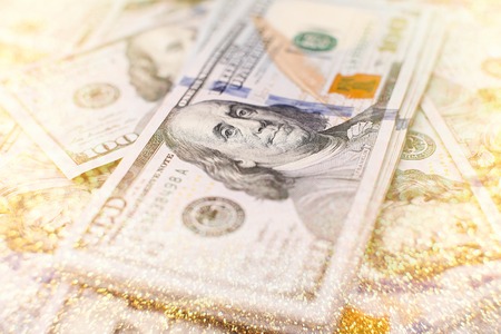 A stack of money. Heap of one hundred dollar bills on money background. Fake money. Shallow depth of...