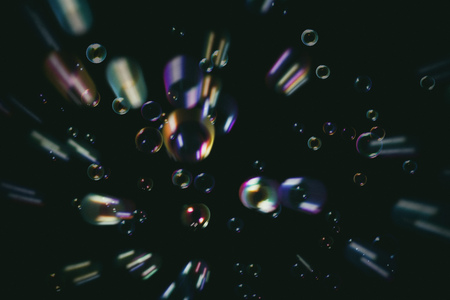 Rainbow soap bubbles on a dark background.の写真素材