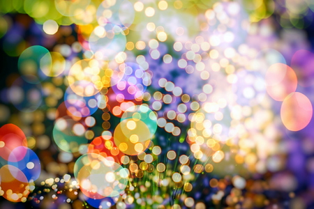 glittering shine bulbs lights background:blur of Christmas wallpaper decorations concept.holiday festival backdrop:sparkle circle lit celebrations display.の写真素材