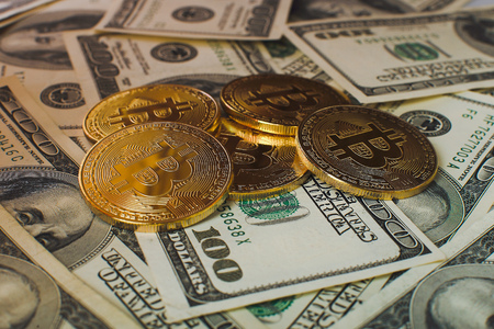 Bitcoin and one cent coin on US dollar bills, macro shotの写真素材