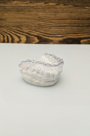 Close-up individual tooth tray Orthodontic dental theme. In hand Invisible braces