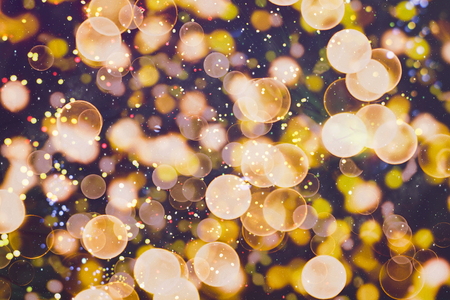 Bright abstract circular bokeh background blur on a dark backgroundの写真素材