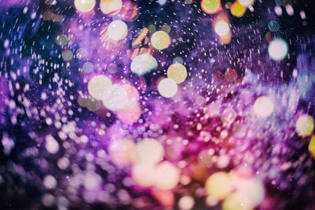 Christmas bokeh glowing Background. Glowing holiday abstract defocused colorful backdrop. Bright vivid blurred colourful new year holiday bokehの写真素材