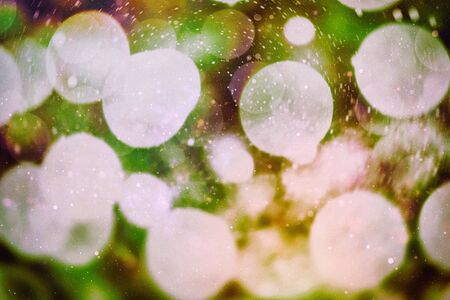 Christmas bokeh glowing Background. Glowing holiday abstract defocused colorful backdrop. Bright vivid blurred colourful new year holiday bokehの写真素材