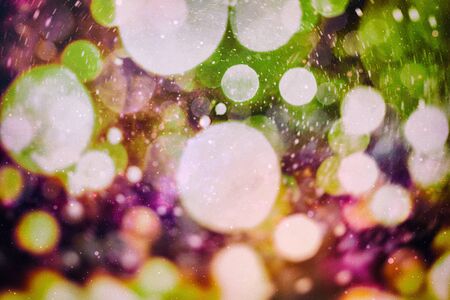 Festive background with natural bokeh and bright golden lights. Vintage magic background with colorful bokeh. Spring summer Christmas new year disco party background.の写真素材