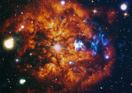 Giant glowing nebula. Space background with red nebula and stars.の写真素材