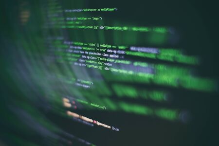 Website codes on computer monitor. Programmer workplace. Abstract screen of software. Computer program.の写真素材
