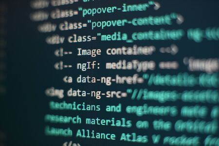 Website codes on computer monitor. Programmer workplace. Abstract screen of software. Computer program.の写真素材