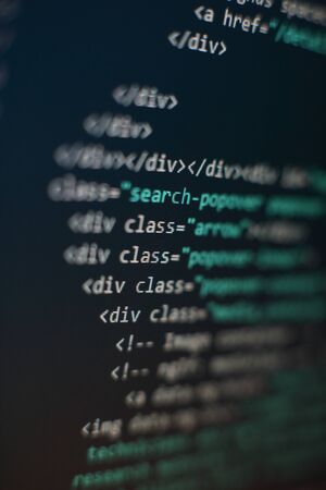Website codes on computer monitor. Programmer workplace. Abstract screen of software. Computer program.の写真素材