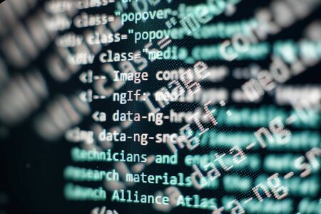 Website codes on computer monitor. Programmer workplace. Abstract screen of software. Computer program.の写真素材