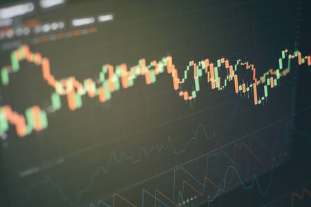 Abstract financial trading graphs on monitor. Background with currency bars and candles