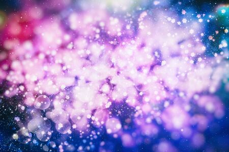 Flying snowflakes on a light blue background. Winter Abstract snowflakes. Falling snow.の写真素材