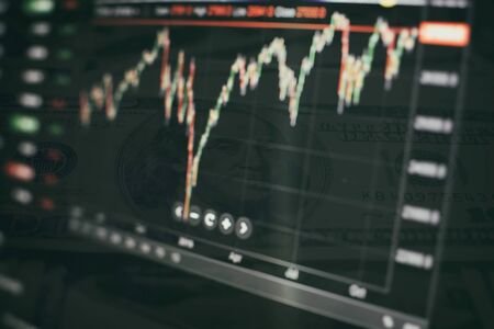 Trading graphs and digital number on monitor. Background of gold and blue digital chart to represent stock market trend.の写真素材