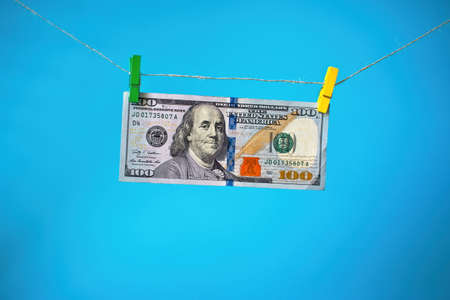 Dollars on a long rope hooked with a clothespinの写真素材