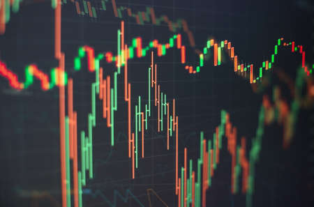 Charts of financial instruments with various type of indicators including volume analysis for professional technical analysis on the monitor of a computer.の写真素材