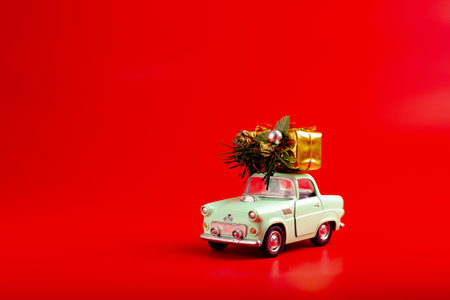 Car with gifts on a red background. New Year's gifts by carの写真素材