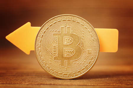 Bitcoins with Candle stick graph chart and digital background.Golden coin with icon letter B. Mining or blockchain technologyの写真素材